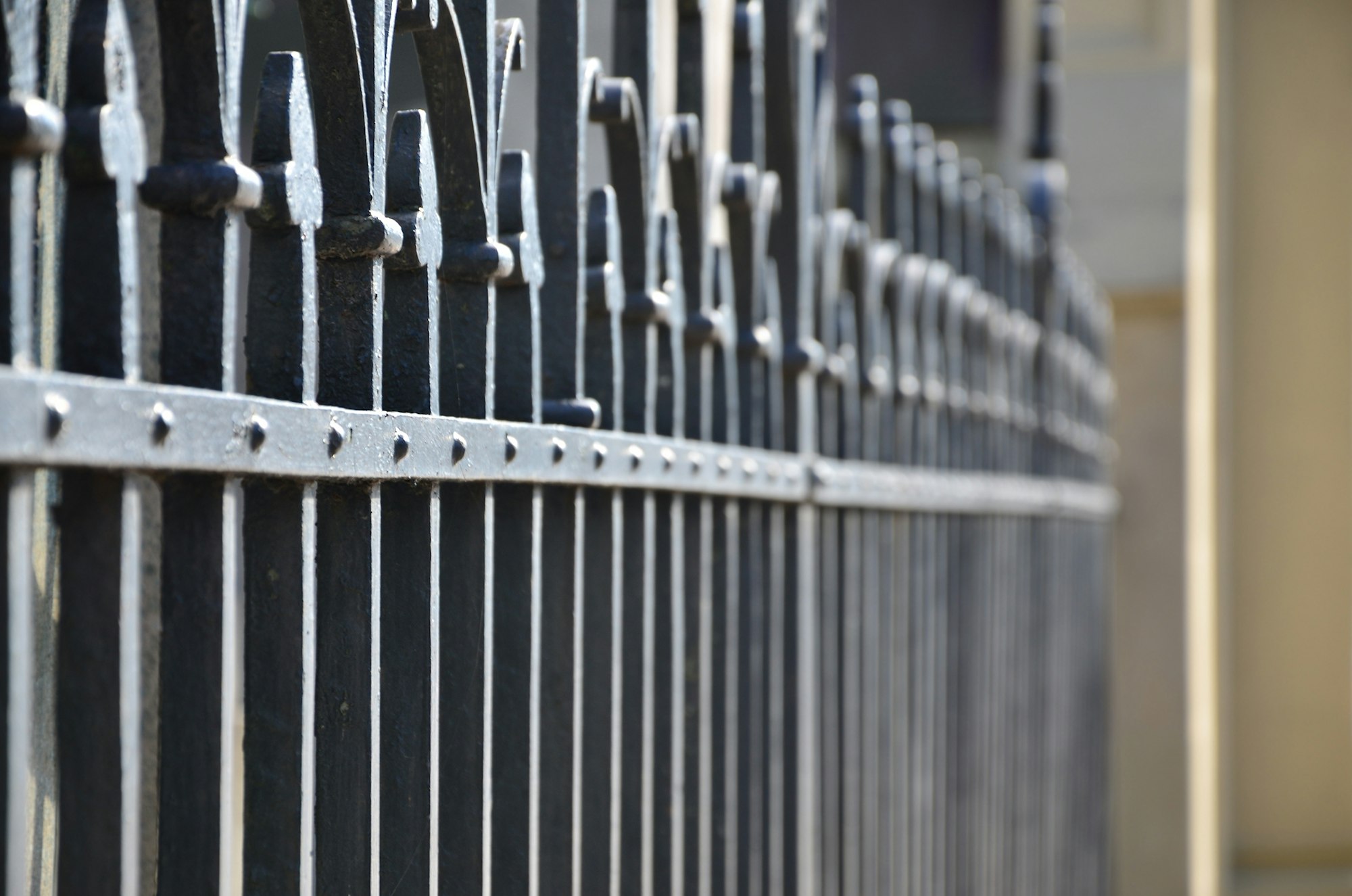 Photo of a decorative metal fence from the cemetery. Selective focus and shallow depth of field