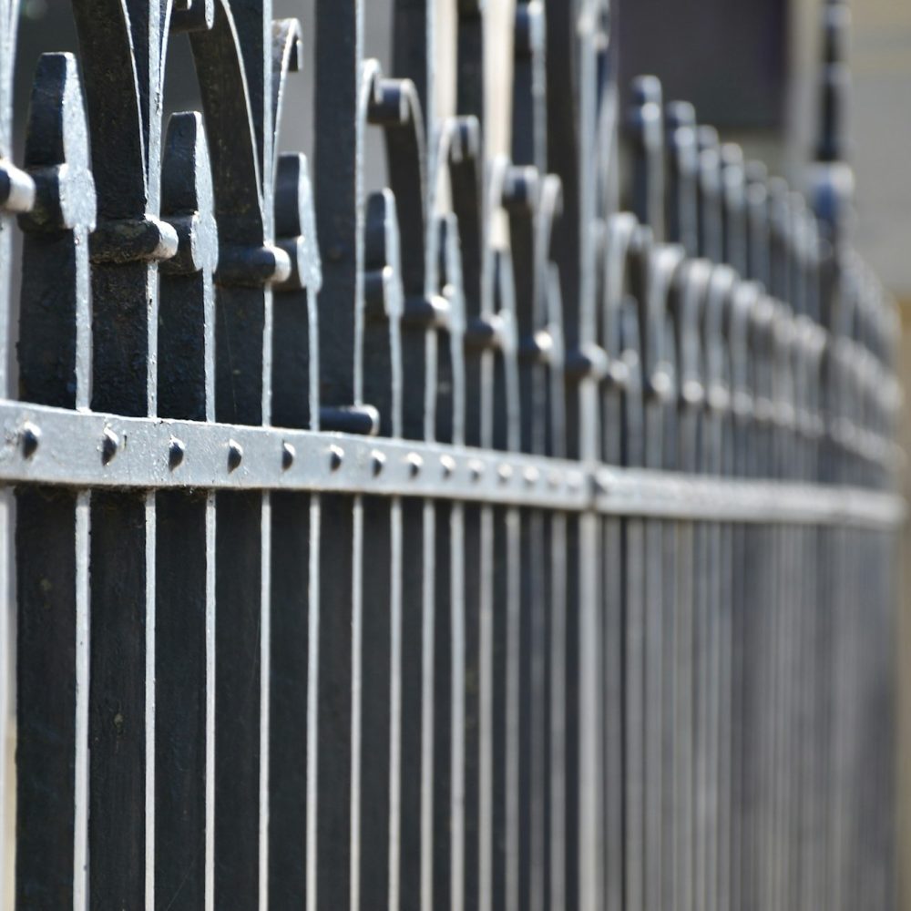 Photo of a decorative metal fence from the cemetery. Selective focus and shallow depth of field